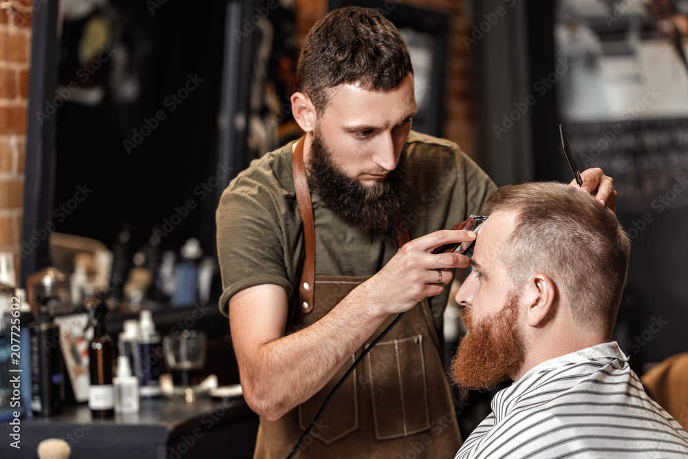 Barber and bearded man in barber shop Barber and bearded man in barber shop