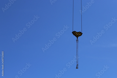 Construction crane against the blue sky.