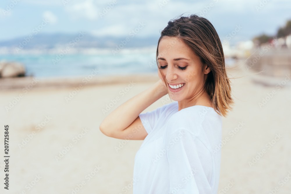 Beautiful, smiling, carefree girl at the beach Beautiful, smiling, carefree girl at the beach