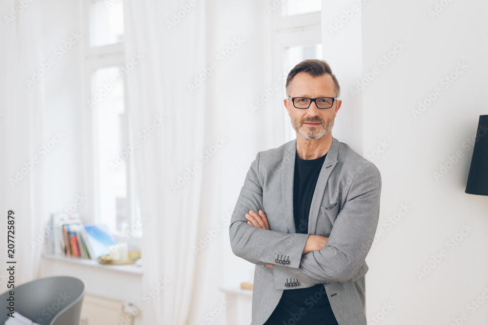 Professional man with arms folded in home scene