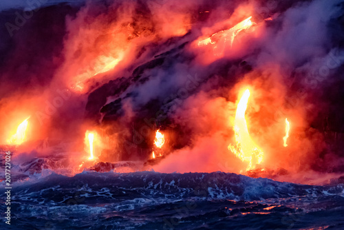 Molten lava flowing into the Pacific Ocean on Big Island of Hawaii at sunrise
