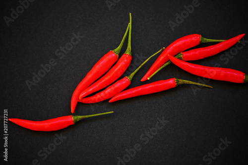 hot red pepper lies on a black background