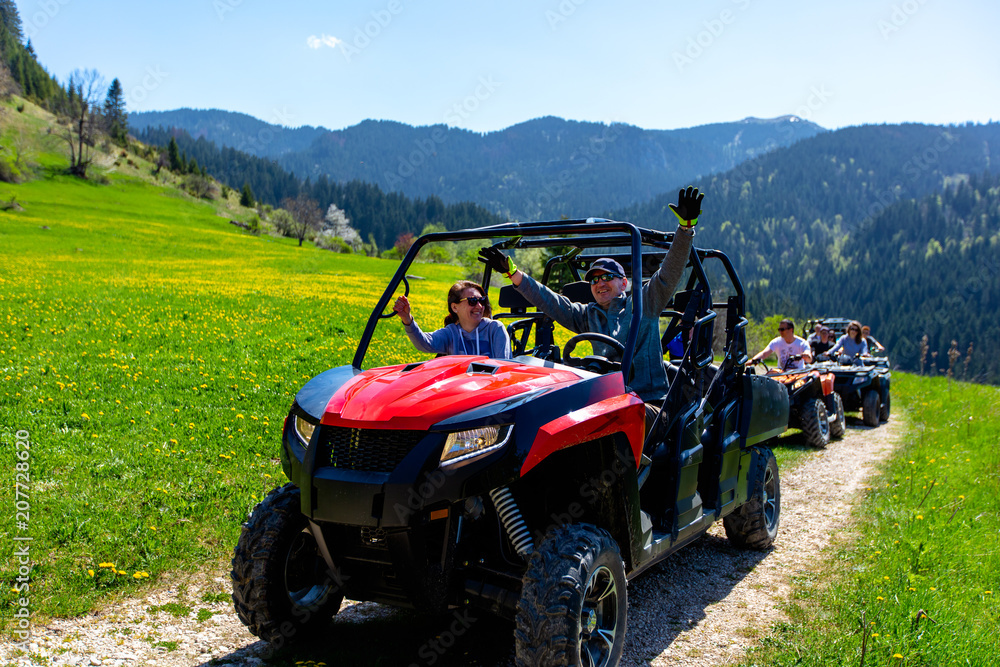 A tour group travels on ATVs and UTVs on the mountains A tour group travels on ATVs and UTVs on the mountains