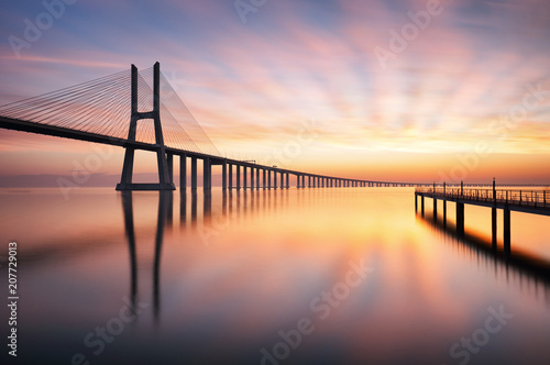 Fototapeta Naklejka Na Ścianę i Meble -  Bridge Lisbon at sunrise, Portugal - Vasco da Gamma