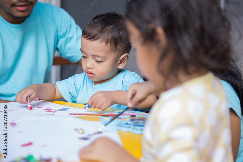 child painting water color with dad