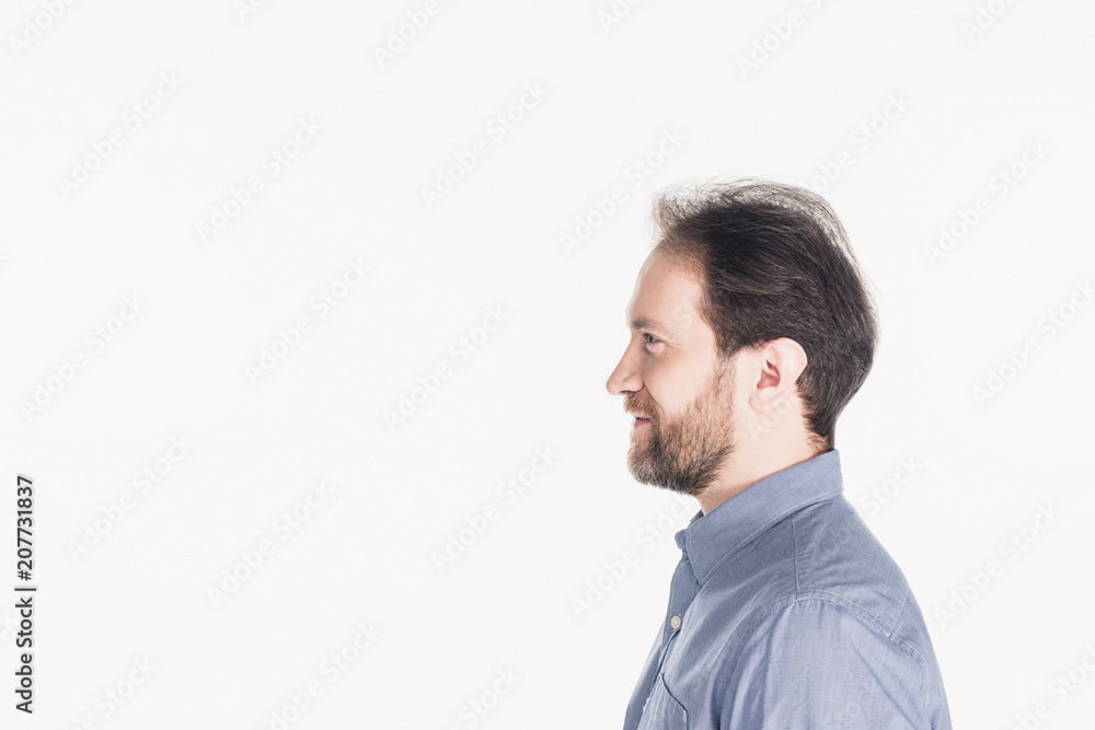 Fototapeta premium side view of smiling bearded man in shirt isolated on white