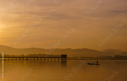 Men are fishing on a boat in a reservoir in the morning. © pic for you