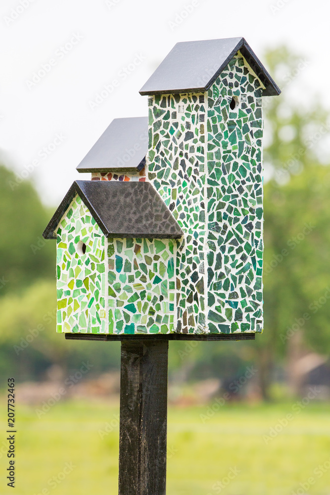 Nest boxes with mosaic tiles on pole Nest boxes with mosaic tiles on pole