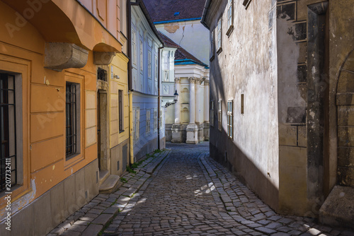 Canvas Print Zamocnicka paved street in historic part of Bratislava city, Slovakia with wall