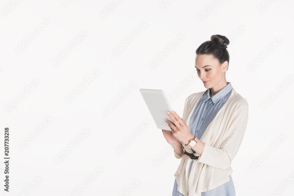 side view of woman in casual clothing using digital tablet isolated on white side view of woman in casual clothing using digital tablet isolated on white