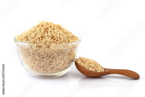 brown rice in glass bowl on white background , healthy food