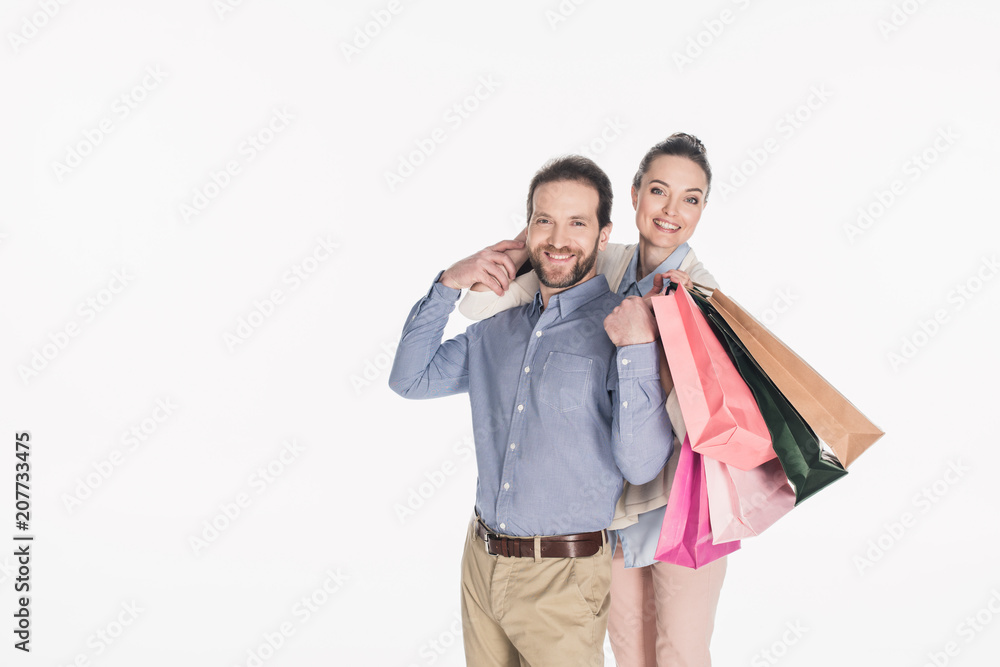 cheerful couple with shopping bags isolated on white cheerful couple with shopping bags isolated on white