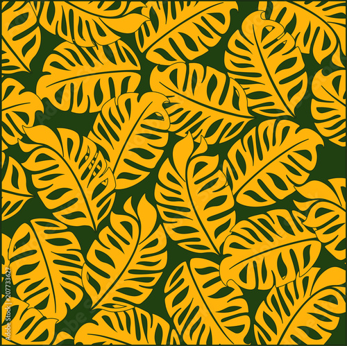 Bright tropical design. On a green background bright yellow tropical leaves.