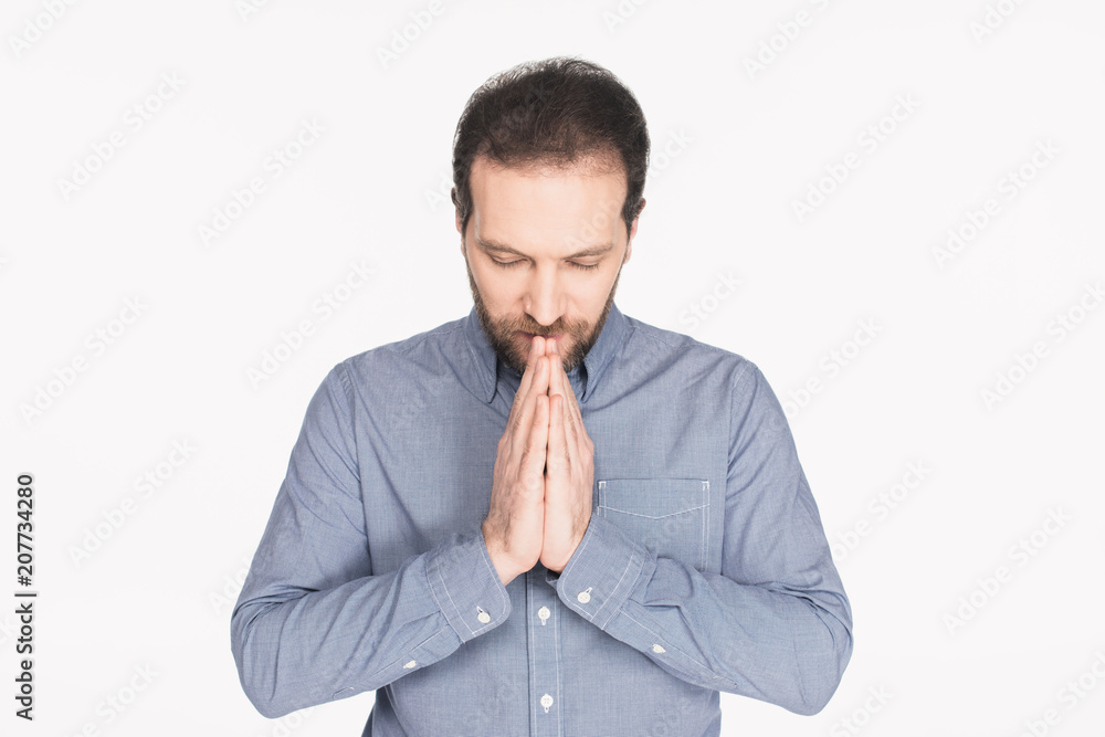 portrait of bearded man in shirt praying isolated on white portrait of bearded man in shirt praying isolated on white