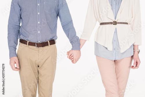 cropped shot of wife and husband holding hands together isolated on white