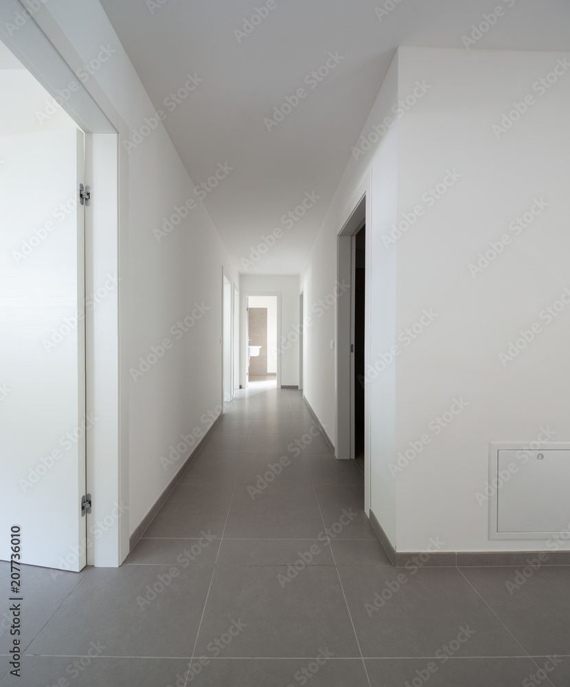 White corridor with many open doors White corridor with many open doors