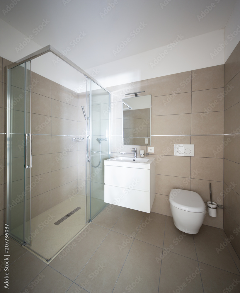 Modern bathroom with large tiles in newly built apartment Modern bathroom with large tiles in newly built apartment