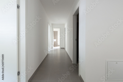 White corridor with many open doors