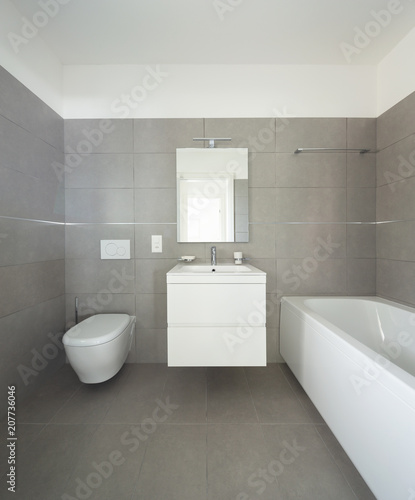 Modern bathroom with large tiles in newly built apartment