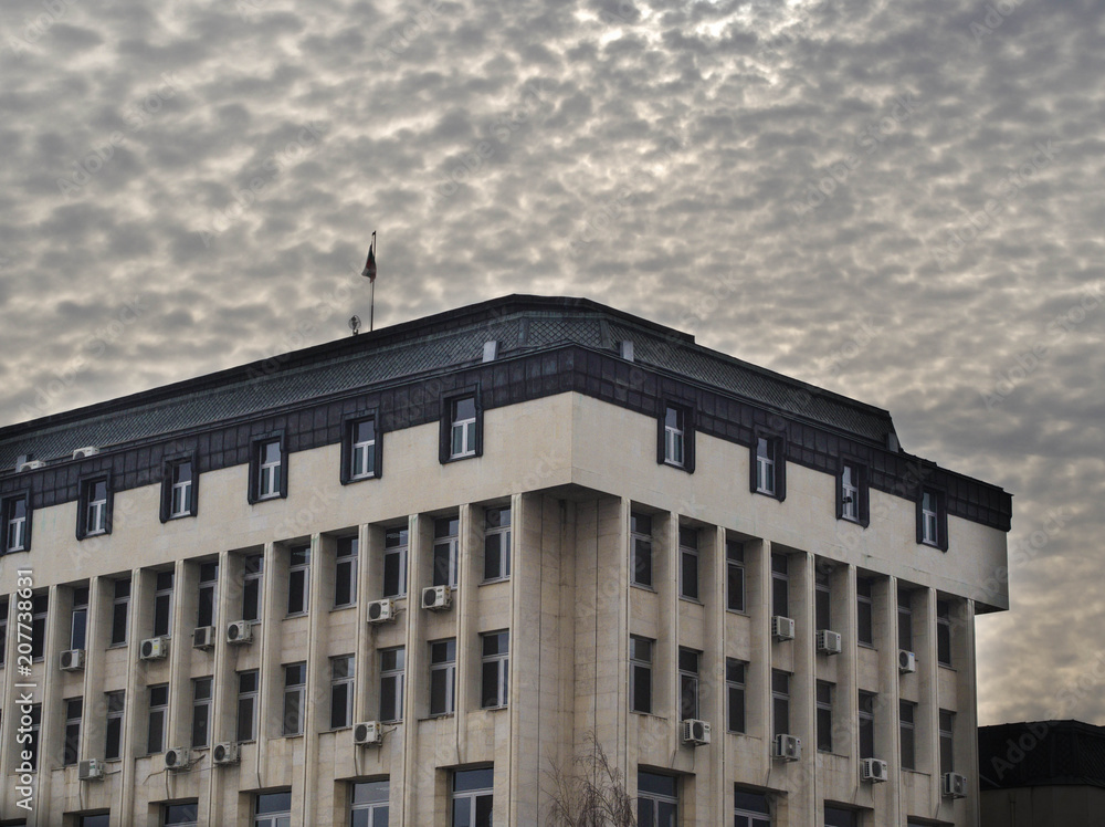 Municipality building under dense clouds