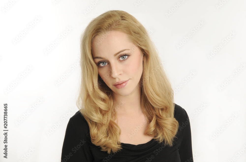 portrait of blonde girl wearing black shirt, on white studio background portrait of blonde girl wearing black shirt, on white studio background