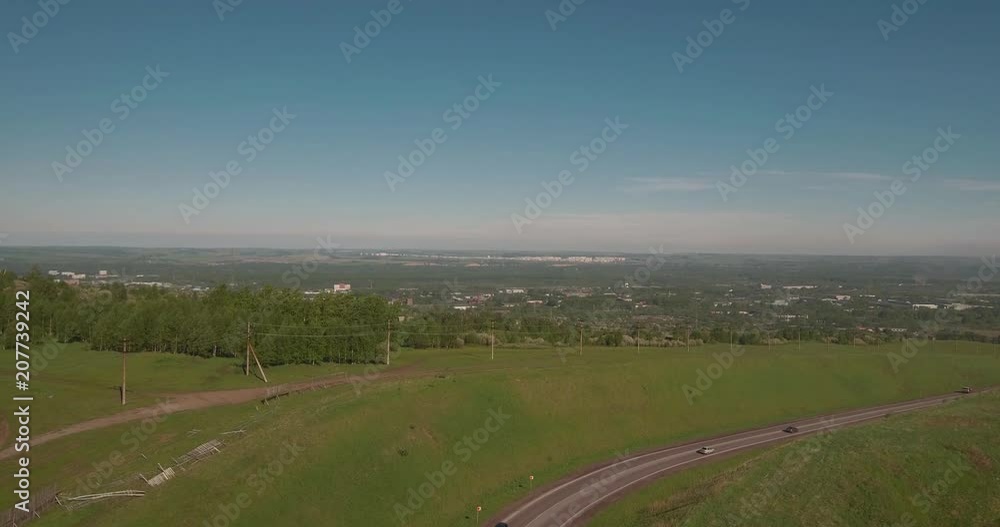 Aerial view. flies between the hills above a road to industrial enterprise. Air pollution from metallurgical plants. 4K Aerial view. flies between the hills above a road to industrial enterprise. Air pollution from metallurgical plants. 4K