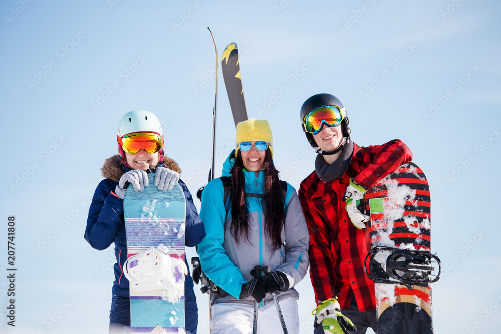 Photo of sports young women and men with snowboard on vacation Photo of sports young women and men with snowboard on vacation