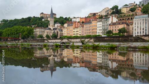 The historical buildings of UNESCO world heritage site Vieux-Lyon reflected in a puddle. Lyon, France.