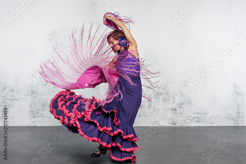 Flamenco dancer in action with the typical Spanish dance costume. photo