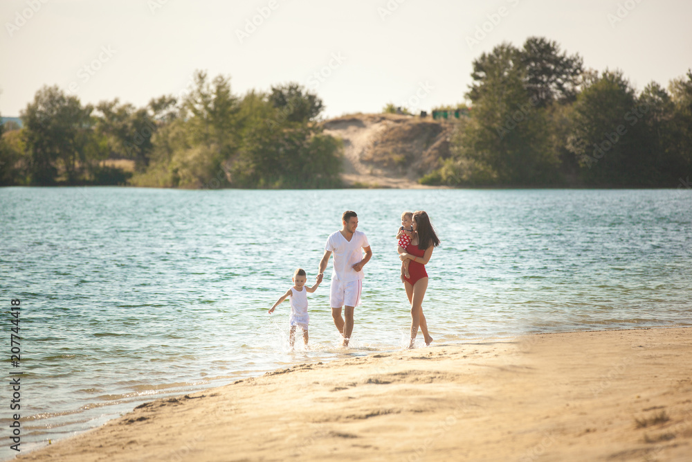Cheerful family on the beach. Family on vacation Cheerful family on the beach. Family on vacation