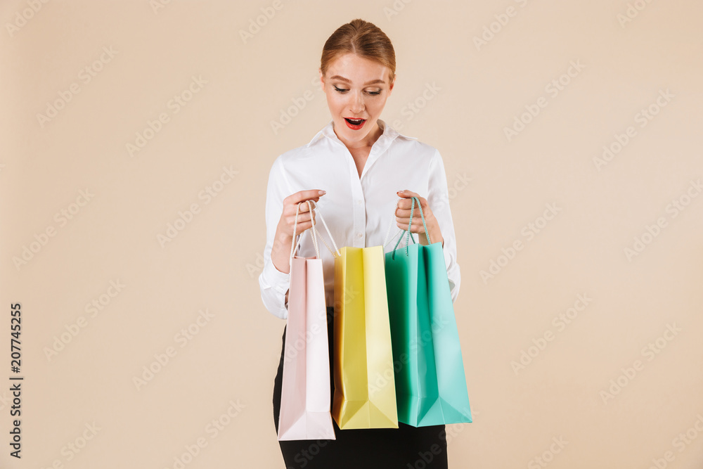 Shocked young business woman holding shopping bags. Shocked young business woman holding shopping bags.