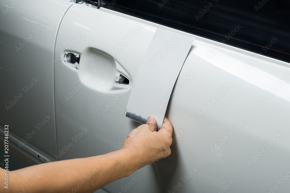 Auto body repair series: Inspector comparing car paint with color palette Auto body repair series: Inspector comparing car paint with color palette