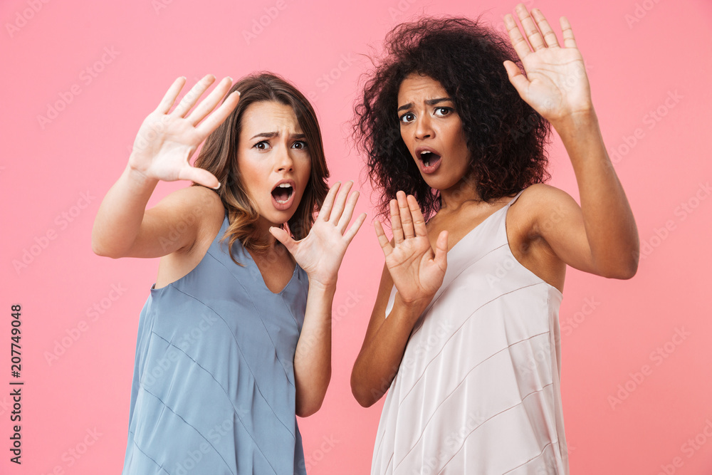 Two frightened young girls dressed in summer clothes Two frightened young girls dressed in summer clothes