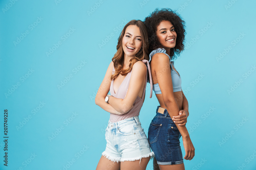 Two happy young girls dressed in summer clothes Two happy young girls dressed in summer clothes