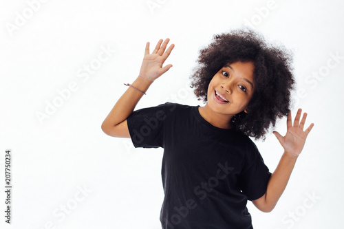Pre-teen African American kid putting hands up being playful and happy isolated over white background