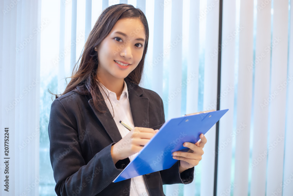 Asian business women smiling happy for working and checking documents Asian business women smiling happy for working and checking documents
