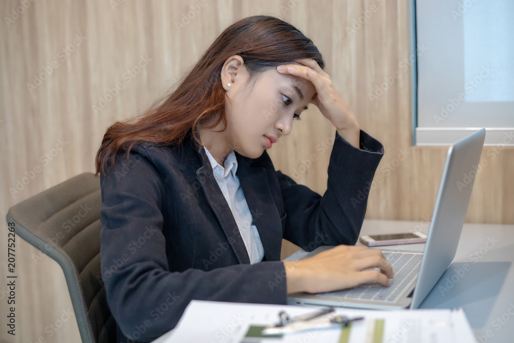 Asian businesswoman serious about the work hard done until the headache Asian businesswoman serious about the work hard done until the headache