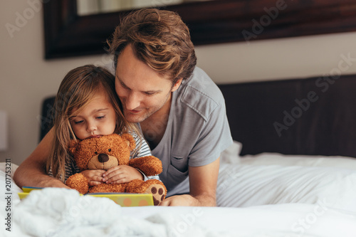 Father and daughter reading a story book