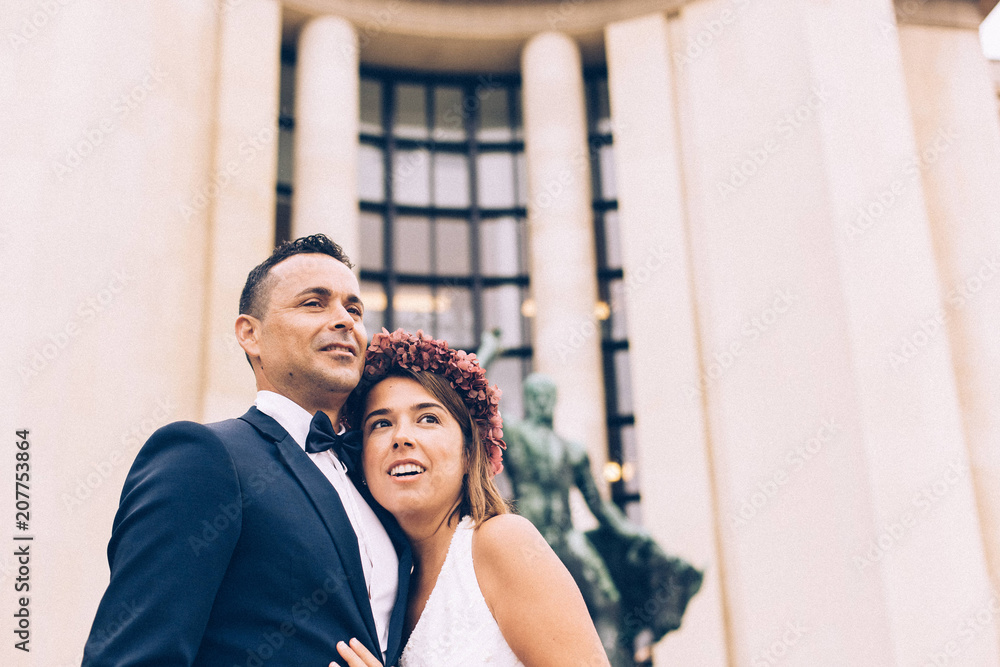 Just married couple in the Eiffel tower on wedding day. Walking an kissing in Paris Just married couple in the Eiffel tower on wedding day. Walking an kissing in Paris
