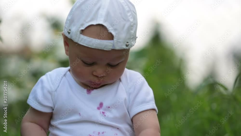 Sweet little child, baby boy, eating cherries in garden, enjoying tasty fruit, getting dirty Sweet little child, baby boy, eating cherries in garden, enjoying tasty fruit, getting dirty