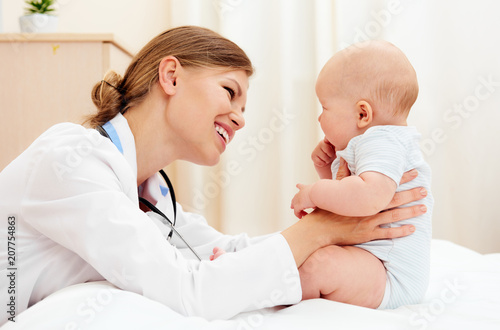 Portrait of little baby with doctor therapist in clinic. 