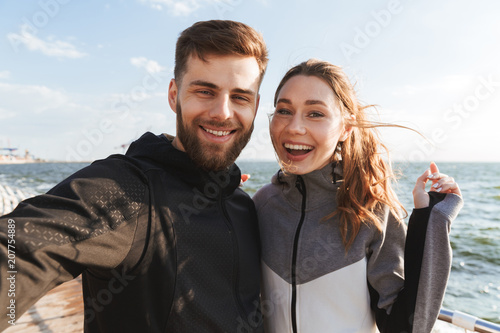 Joyful young sports couple taking a selfie