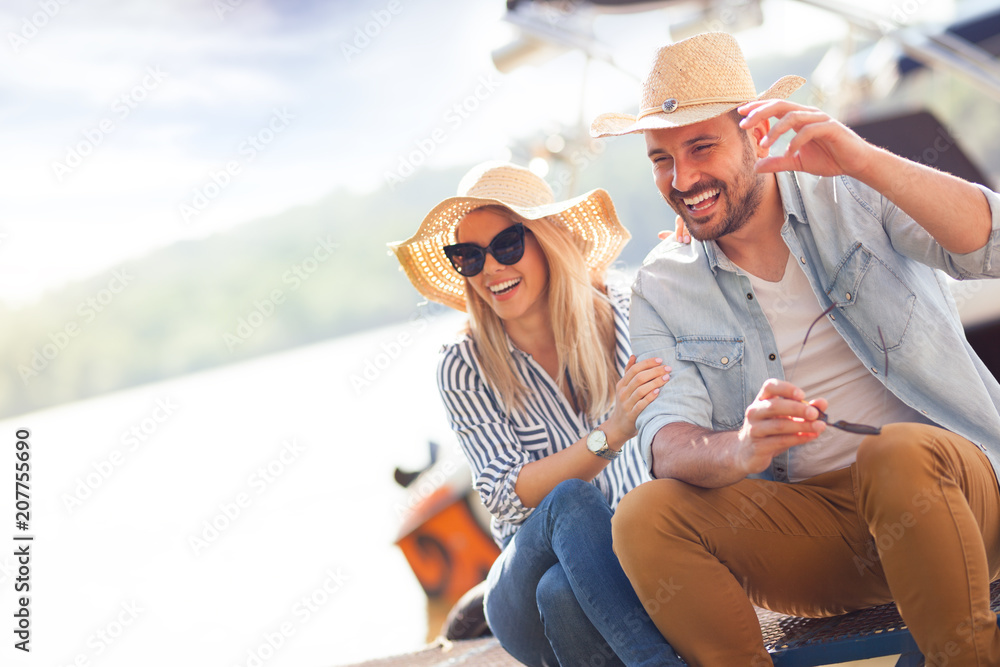 Smiling couple with straw hats