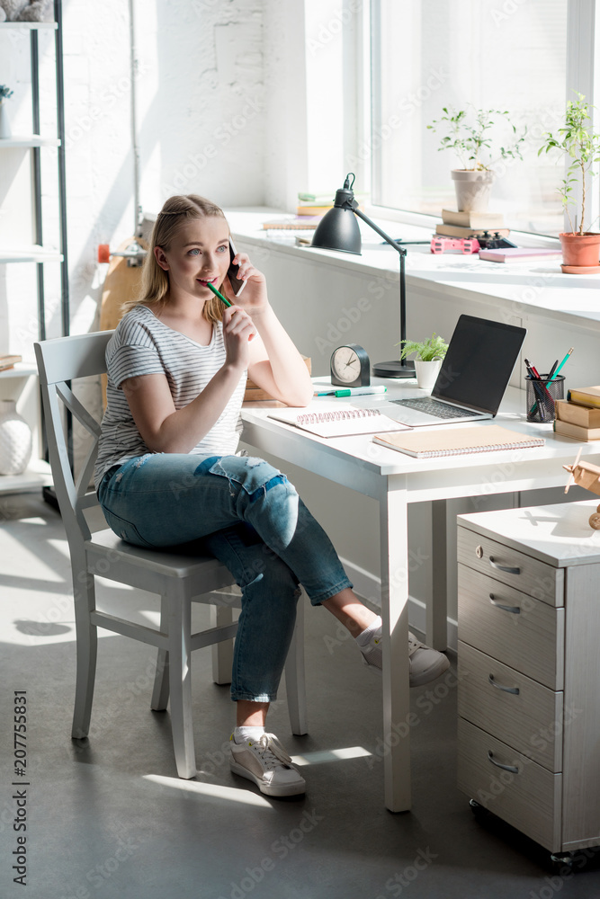 teen student girl talking by phone while doing homework teen student girl talking by phone while doing homework