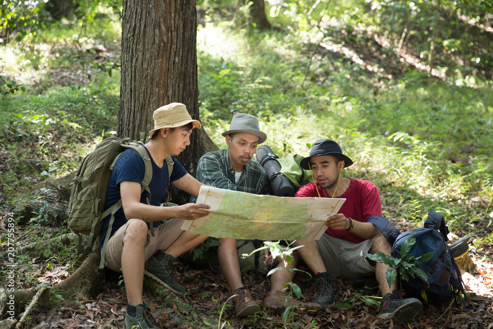 people hiker sitting and talking about the map people hiker sitting and talking about the map