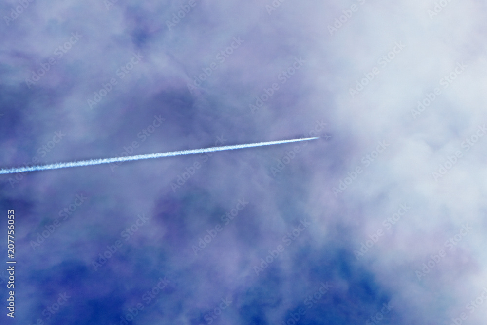 The passenger plane flies away beyond the horizon The plane flies over the clouds during the sunset Rear view of aircraft. The passenger plane flies away beyond the horizon The plane flies over the clouds during the sunset Rear view of aircraft.