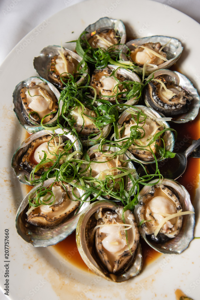 Steamed abalone dish at a chinese restaurant a very popular dish at asian wedding reception ceremonies Steamed abalone dish at a chinese restaurant a very popular dish at asian wedding reception ceremonies