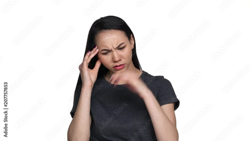Portrait of exhausted asian woman 20s feeling sick massaging temples with fingers and suffering from strong headache or migraine, over white background. Concept of emotions Portrait of exhausted asian woman 20s feeling sick massaging temples with fingers and suffering from strong headache or migraine, over white background. Concept of emotions