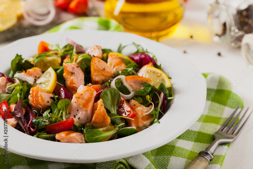 Delicious salad with pieces of grilled salmon. Delicious salad with pieces of grilled salmon.
