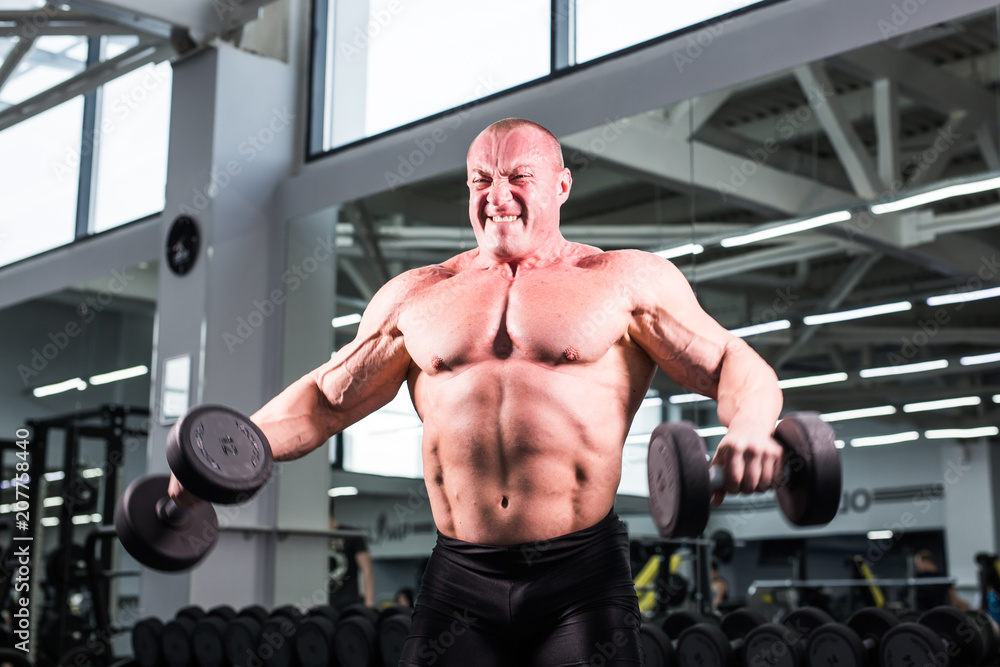 Muscular bodybuilder guy in gym Muscular bodybuilder guy in gym